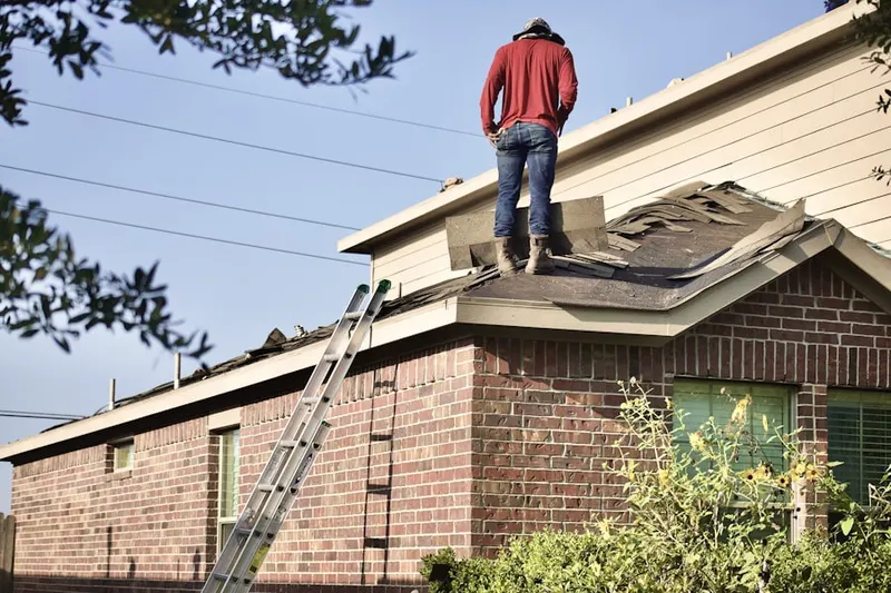 Professional roofer working on a residential roof in Preserve North